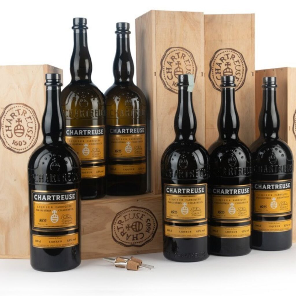 rare bottles of chartreuse in a line with original wood cases